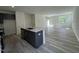Modern kitchen with island and stainless appliances overlooks the living area with sliding doors to a backyard at 136 Parker Ln, Mebane, NC 27302