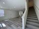 Open floorplan featuring a carpeted staircase next to a large sunny living room at 136 Parker Ln, Mebane, NC 27302