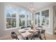 Elegant dining room with a table for six and large windows at 139 Quail Pt, Pittsboro, NC 27312