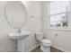 Clean bathroom with pedestal sink and window at 1701 Mallard Trace Dr, Wendell, NC 27591