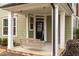 Covered porch with a wooden swing, inviting entryway at 1701 Mallard Trace Dr, Wendell, NC 27591