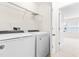 Laundry room with washer, dryer, and shelving at 1701 Mallard Trace Dr, Wendell, NC 27591