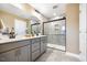 Modern bathroom featuring double vanities, sleek fixtures, and a spacious glass-enclosed shower at 201 Broomgrove Way, Wake Forest, NC 27587