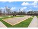 Bocce ball court with manicured grass, surrounded by trees and sky at 201 Broomgrove Way, Wake Forest, NC 27587