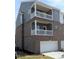 New construction features two-story balconies, brick and siding, and attached two-car garages at 201 Broomgrove Way, Wake Forest, NC 27587