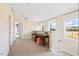 Bright hallway with natural light, neutral colors, and views of the outdoors from the windows at 201 Broomgrove Way, Wake Forest, NC 27587