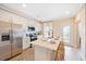 Bright kitchen featuring white cabinetry, quartz countertops, stainless appliances, and island seating at 201 Broomgrove Way, Wake Forest, NC 27587