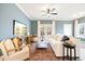 Living room showcasing blue walls, French doors, and modern furniture at 201 Broomgrove Way, Wake Forest, NC 27587