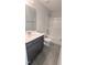 Bathroom with gray vanity, and tub with tile flooring and shower at 205 Broomgrove Way, Wake Forest, NC 27587