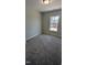 Cozy carpeted bedroom with natural light from the large window at 205 Broomgrove Way, Wake Forest, NC 27587