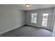 Bright bedroom with neutral carpet, window view and access to an outdoor terrace at 205 Broomgrove Way, Wake Forest, NC 27587