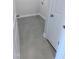Clean laundry room with gray tile floor and white trim at 205 Broomgrove Way, Wake Forest, NC 27587