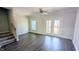 Spacious living room with hardwood floors, a ceiling fan, and access to outdoor balcony at 205 Broomgrove Way, Wake Forest, NC 27587