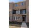 Modern brick townhome with covered entry and balcony, offering stylish urban living at 205 Broomgrove Way, Wake Forest, NC 27587