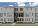 Rendering of brick townhome with stylish exterior, featuring a welcoming entrance and covered balcony at 205 Broomgrove Way, Wake Forest, NC 27587