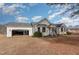 House exterior showcasing a garage and open yard at 210 Alfalfa Ct, Smithfield, NC 27577