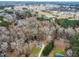 Aerial view of a house on a wooded lot, showcasing its location and surrounding area at 210 Charlotte Ct, Clayton, NC 27520