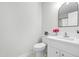 Clean bathroom with white vanity and a large mirror at 210 Charlotte Ct, Clayton, NC 27520