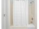 Simple bathroom with a shower/tub combo and white shower curtain at 210 Charlotte Ct, Clayton, NC 27520