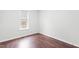 Spacious bedroom with dark wood floors and a large window at 210 Charlotte Ct, Clayton, NC 27520