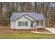 Gray house exterior with dark metal roof and landscaping at 210 Charlotte Ct, Clayton, NC 27520