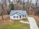 House exterior showcasing gray siding and a dark metal roof at 210 Charlotte Ct, Clayton, NC 27520