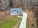 Aerial view of a house exterior, showcasing gray siding and a dark metal roof at 210 Charlotte Ct, Clayton, NC 27520