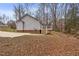 Grey house exterior with a deck and wooded backyard at 210 Charlotte Ct, Clayton, NC 27520