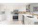 Updated kitchen featuring white cabinets, quartz countertops, and stainless steel appliances at 210 Charlotte Ct, Clayton, NC 27520
