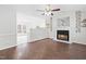 Living room with a fireplace, hardwood floors, and kitchen views at 210 Charlotte Ct, Clayton, NC 27520