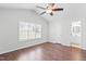 Main bedroom with wood floors, vaulted ceiling, and door to bathroom at 210 Charlotte Ct, Clayton, NC 27520