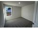 Bright bedroom with carpet flooring and a large window at 241 Magnolia Run Way, Benson, NC 27504