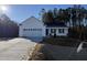 White house with two-car garage and landscaping at 241 Magnolia Run Way, Benson, NC 27504