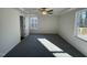 Spacious main bedroom featuring carpet, a ceiling fan, and multiple windows at 241 Magnolia Run Way, Benson, NC 27504