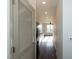 Bright hallway with wood flooring and view into kitchen at 2426 Gathering Square Ct # 2426, Fuquay Varina, NC 27526