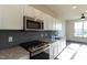 Modern kitchen with stainless steel appliances and granite countertop at 2426 Gathering Square Ct # 2426, Fuquay Varina, NC 27526