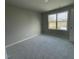 Bright bedroom featuring a window with a view and neutral walls at 309 Starry Sky Dr, Benson, NC 27504