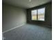 Bright bedroom featuring a window with a view and neutral walls at 309 Starry Sky Dr, Benson, NC 27504