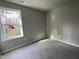 Spacious bedroom with carpeted floor and large window at 309 Starry Sky Dr, Benson, NC 27504