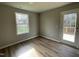 Cozy bedroom with wood-look floors and access to a deck at 309 Starry Sky Dr, Benson, NC 27504