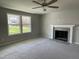Bright living room featuring a fireplace and large windows at 309 Starry Sky Dr, Benson, NC 27504