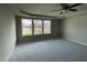 Spacious main bedroom with three windows and carpeted floor at 309 Starry Sky Dr, Benson, NC 27504