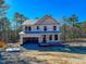 New two-story home under construction with a visible foundation and an attached garage, ready for customization at 346 Duncan Creek Rd # 160, Lillington, NC 27546