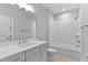 Modern bathroom with white vanity, large mirror, and a bathtub featuring white subway tiles at 3913 Cedar Knolls # 7, Youngsville, NC 27596