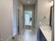 Hallway view to luxurious bathroom featuring stylish fixtures, bright lighting, and elegant design at 3913 Cedar Knolls # 7, Youngsville, NC 27596