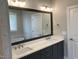 Bathroom with double sink vanity, modern lighting, and a large mirror reflecting the soaking tub at 3913 Cedar Knolls # 7, Youngsville, NC 27596