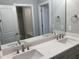 Bathroom boasts a double sink vanity and a large mirror, reflecting bright lights and stylish design at 3913 Cedar Knolls # 7, Youngsville, NC 27596