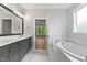 Light and bright primary bathroom with double vanity, garden tub, and natural light at 3913 Cedar Knolls # 7, Youngsville, NC 27596