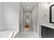 Luxurious bathroom featuring a soaking tub, double vanity, and walk-in closet access at 3913 Cedar Knolls # 7, Youngsville, NC 27596