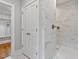 Bright bathroom featuring luxurious marble tile shower with bronze fixtures and nearby linen closet with custom shelves at 3913 Cedar Knolls # 7, Youngsville, NC 27596